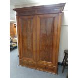 A 19th century continental mahogany two drawer wardrobe