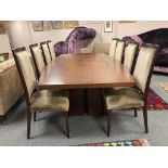 A contemporary nine piece dining room suite comprising of tonneau-shaped hardwood table 130 cm x