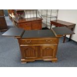 A contemporary mahogany effect side cabinet with fitted cupboards and a drawer