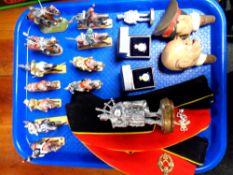 A tray containing two military cloth hats bearing badges,