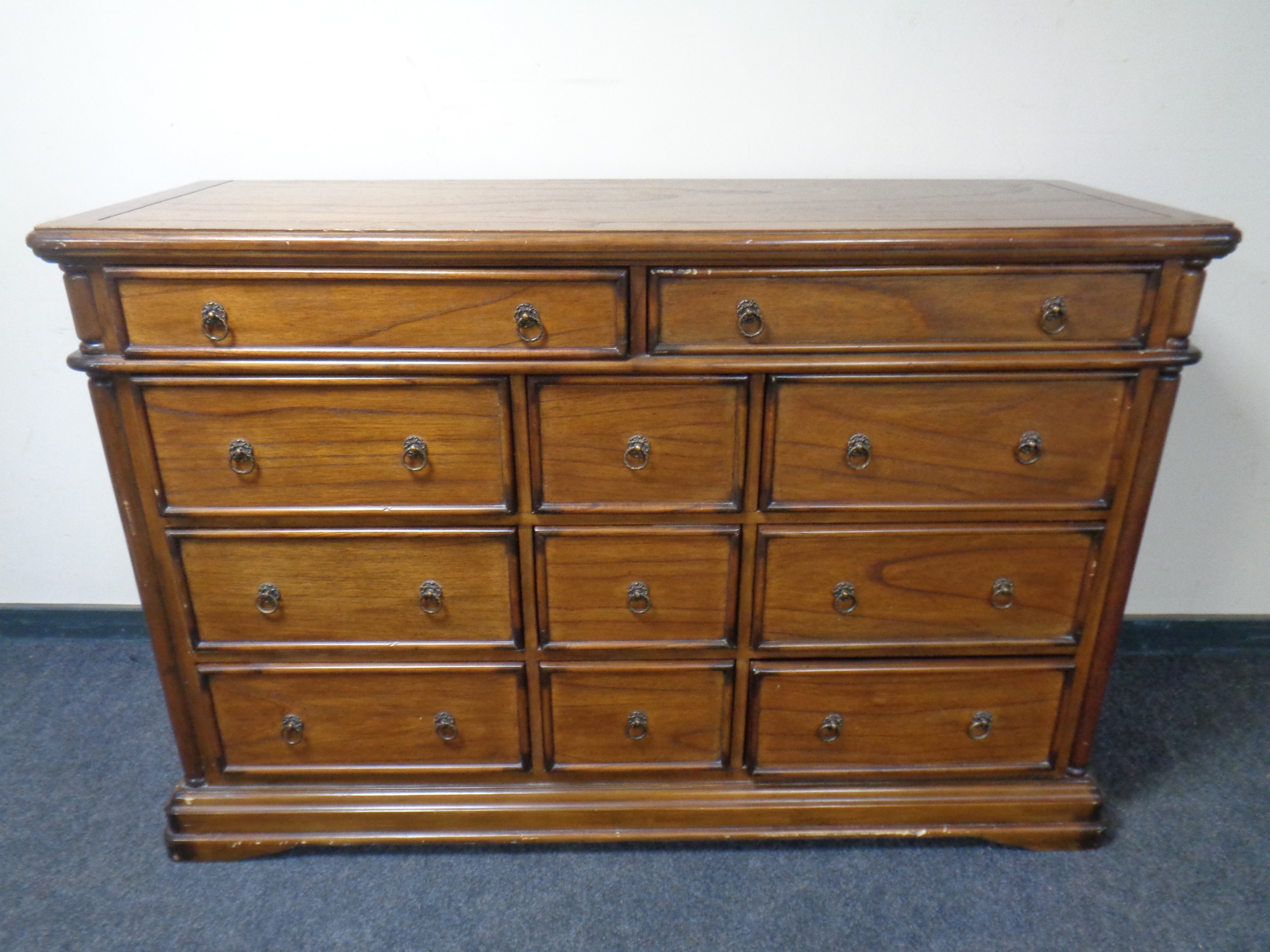 A Colonial style eleven drawer chest