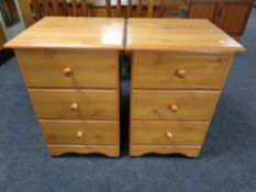 A pair of pine effect three drawer bedside chests