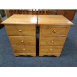 A pair of pine effect three drawer bedside chests