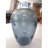 A textured blue glass vase