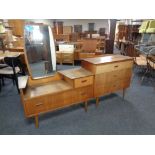 A 20th century teak three drawer chest with a similar mirror back low dressing table