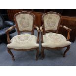 A pair of continental carved beech salon armchairs in tapestry fabric