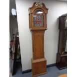 A continental oak longcase clock with brass and silver dial signed Christian Wiuvel with pendulum