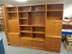 A 20th century teak veneered three section modular bookcase