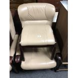 A beech framed cream leather upholstered armchair and matching footstool