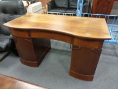 A continental beech twin pedestal writing desk