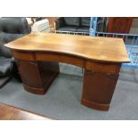 A continental beech twin pedestal writing desk