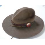 A vintage scouting hat (size six and five eighths) with enamelled boy scout bag