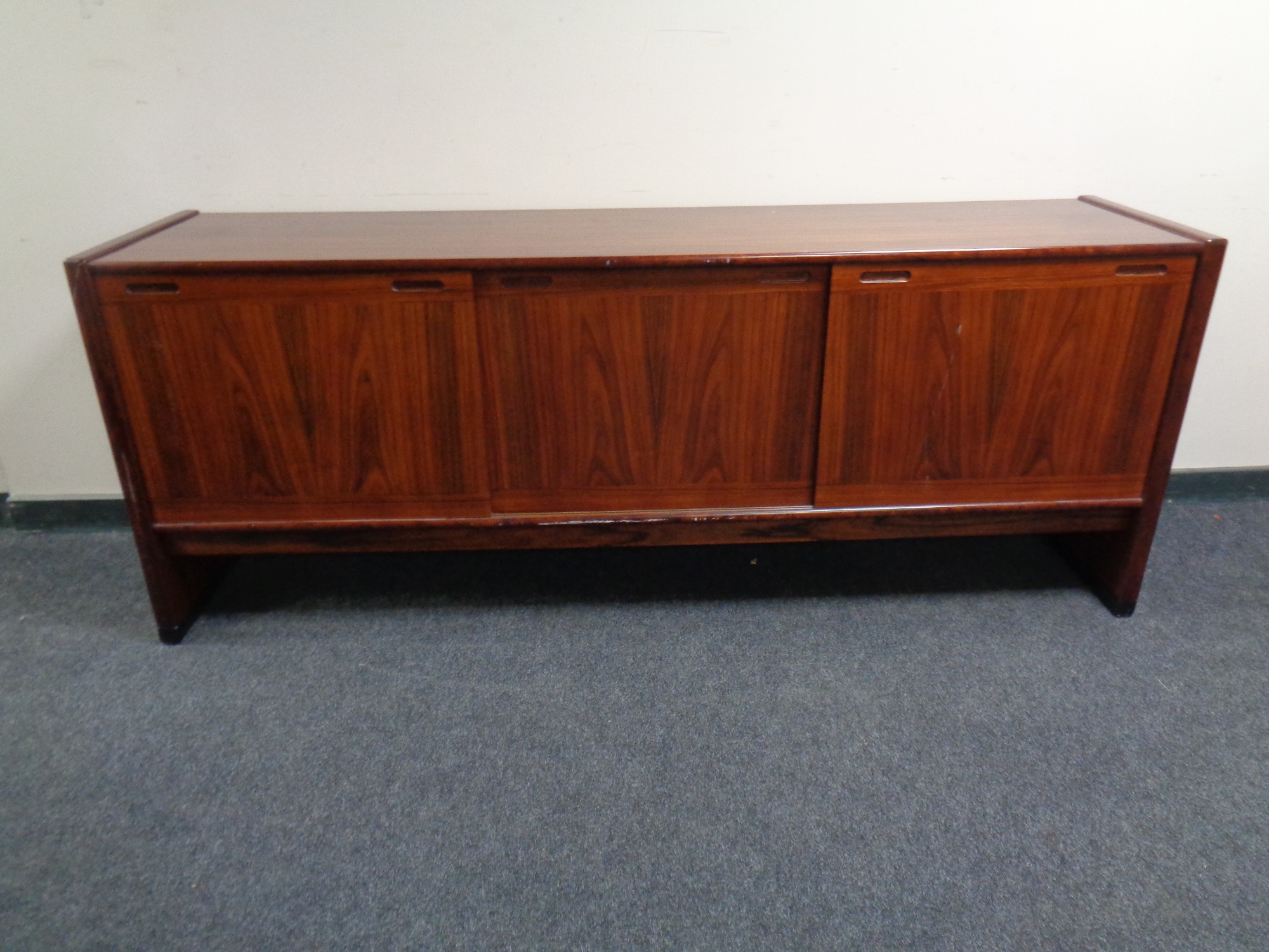 A Skovby teak sliding door low sideboard