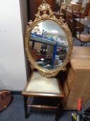 An Edwardian bedroom chair with an oval gilt framed mirror