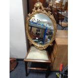 An Edwardian bedroom chair with an oval gilt framed mirror