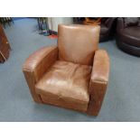 A brown leather upholstered club armchair