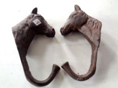 Two cast iron horse coat hooks
