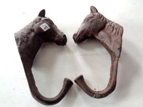 Two cast iron horse coat hooks