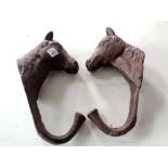 Two cast iron horse coat hooks