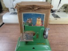 A child's 20th century Little Betty sewing machine with a chrome AA badge