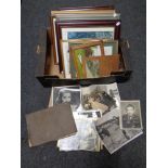 A box containing black and white framed photographs with a quantity of pictures and prints