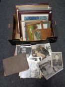 A box containing black and white framed photographs with a quantity of pictures and prints
