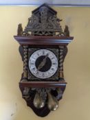 A continental wall clock with brass pair drop weights