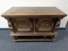 A 19th century carved oak low cabinet