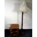 A stained beech standard lamp together with an oak book table