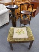 A turned wooden plant stand with a cake stand and a floral embroidered stool