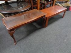 A mahogany glass topped coffee table together with a further low table