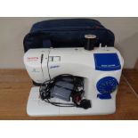 A Toyota Jeans electric sewing machine with foot pedal in carry bag