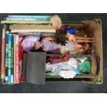 A box containing dolls, unboxed die-cast vehicles, vintage wooden dolls crib,