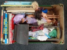 A box containing dolls, unboxed die-cast vehicles, vintage wooden dolls crib,