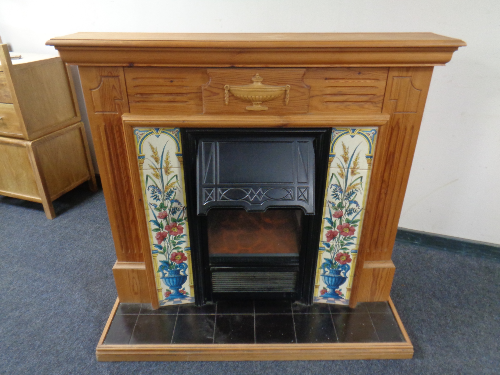 A contemporary electric fire insert in pine surround