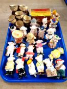 A tray of Friar Chucky ceramic egg holder and quantity of china pig ornaments