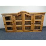 A pine four door dome topped bookcase top