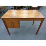 A 20th century continental teak writing desk fitted with three drawers