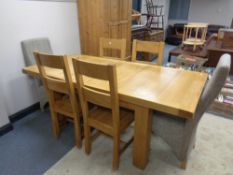 A contemporary oak extending dining table with two leaves with a matching set of six dining chairs