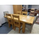 A contemporary oak extending dining table with two leaves with a matching set of six dining chairs