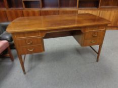 A continental teak desk fitted with six drawers