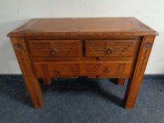 A stained pine side table fitted with three drawers