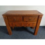 A stained pine side table fitted with three drawers