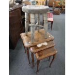 A beech nest of three tables together with a rustic stool