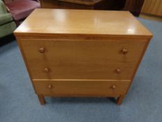 A 20th century teak three drawer chest