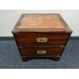 A campaign style two drawer chest with leather inset top