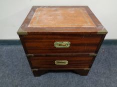 A campaign style two drawer chest with leather inset top