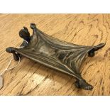 An antique brass calling card tray in the form of The Devil Under an Outstretched Blanket,