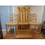 A pine coat rack with a pair of chairs,