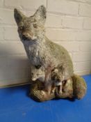 A concrete garden fox and cub figure